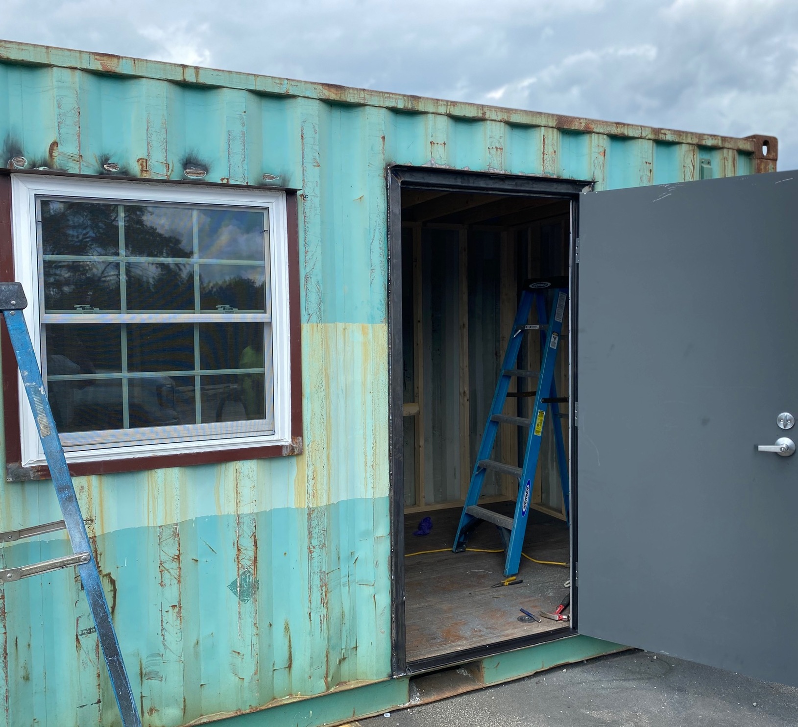 Teal storage container being modified